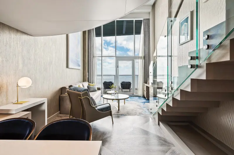 Modern living room with large windows and minimalist decor.