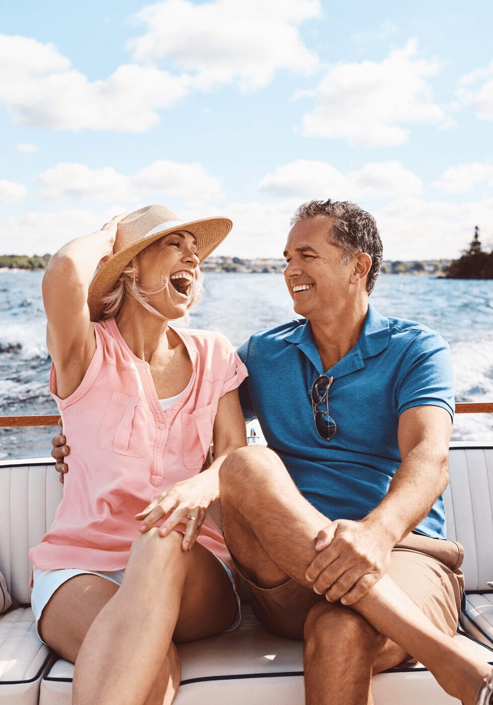 Happy couple enjoying a sunny boat ride together.