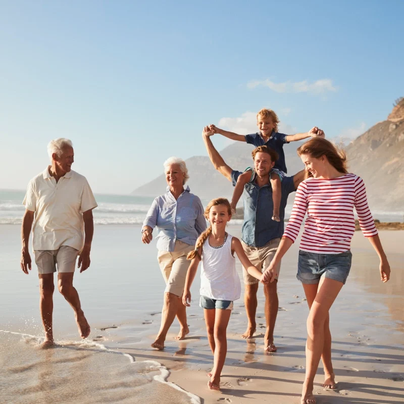 A joyful family walking along the beach at sunset.